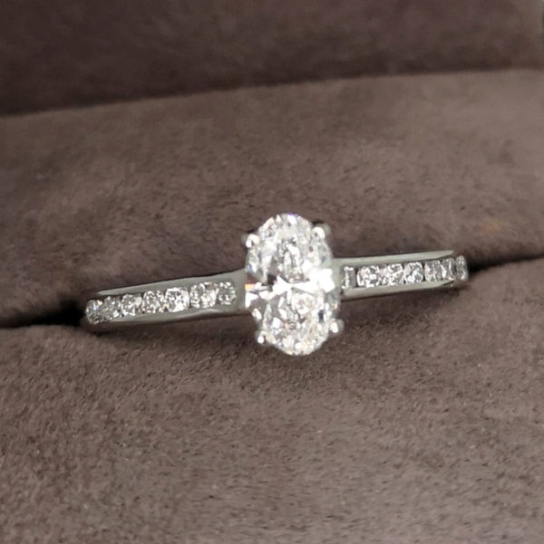 0.69 Carat Oval Cut Diamond Solitaire Ring with Channel Set Shoulders